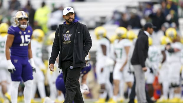 Nov 6, 2021; Seattle, Washington, USA; Washington Huskies head coach Jimmy Lake watches pregame warmups against the Oregon Ducks at Alaska Airlines Field at Husky Stadium.
